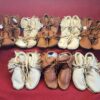 Assorted leather moccasins displayed on fabric.