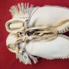Traditional handmade leather moccasins with fringe.