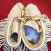 Traditional leather moccasins with fringe detail.