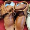 Leather moccasins with decorative stitching.