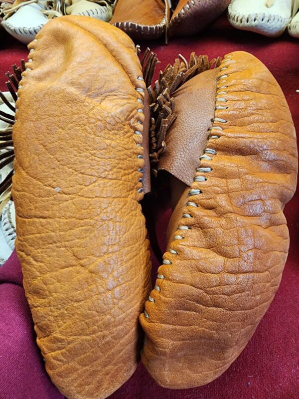 Traditional leather moccasins on display.