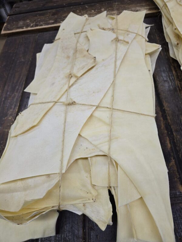 Bundles of dried, flat animal hides.