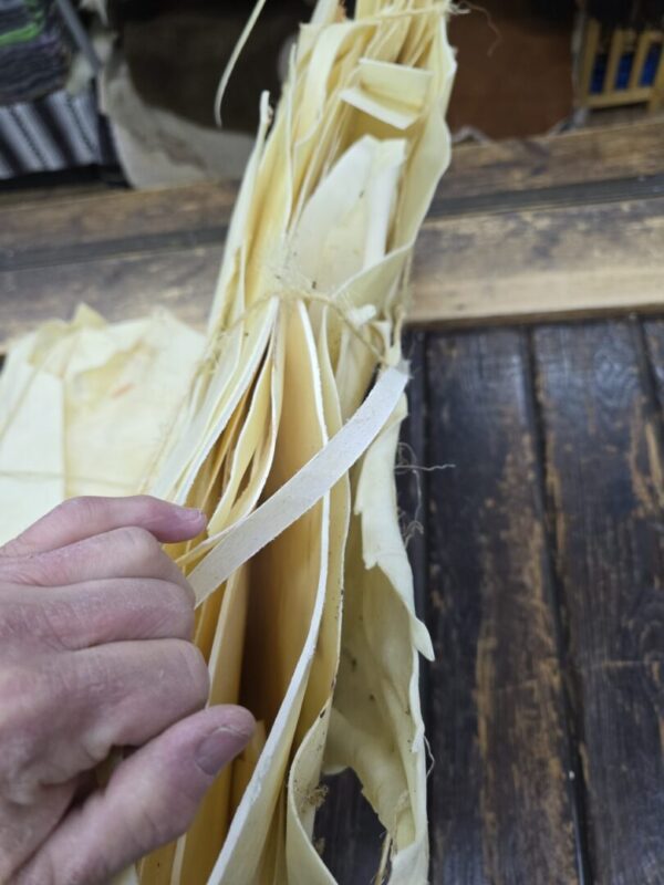 Close-up of hands handling layered paper sheets.