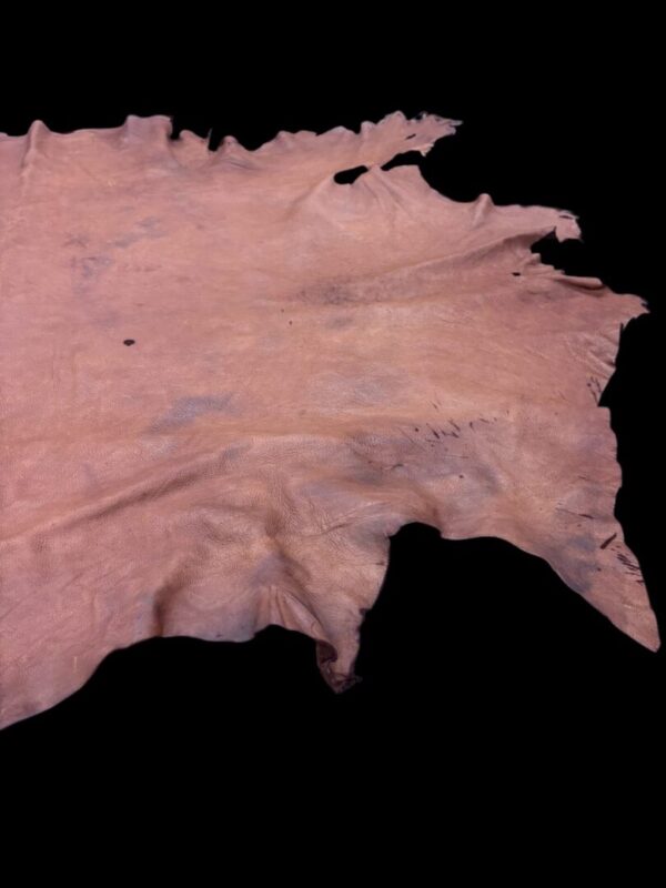 Natural leather hide on black background.