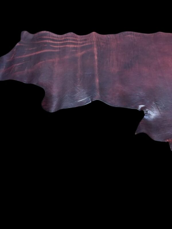 Brown leather piece with uneven edges.