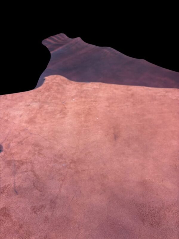 Brown textured surface with dark edges.