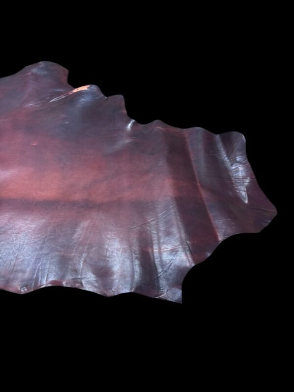 NRAA8222 Brown textured leather piece on black background.