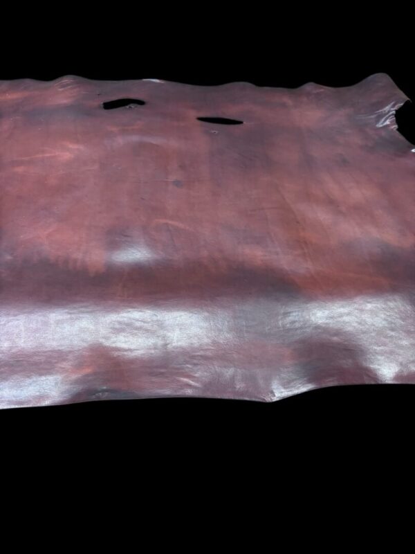 OHJM5779 Brown leather hide on a black background.