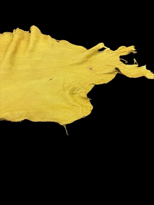 Yellow cloth draped against a black background.