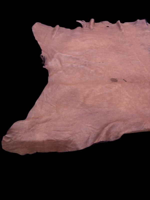 Raw leather hide on a black background.