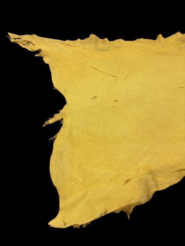 Yellow piece of leather on black background.