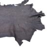 Dark textured leather hide on white background.