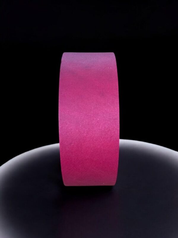 Pink tape roll on black background.