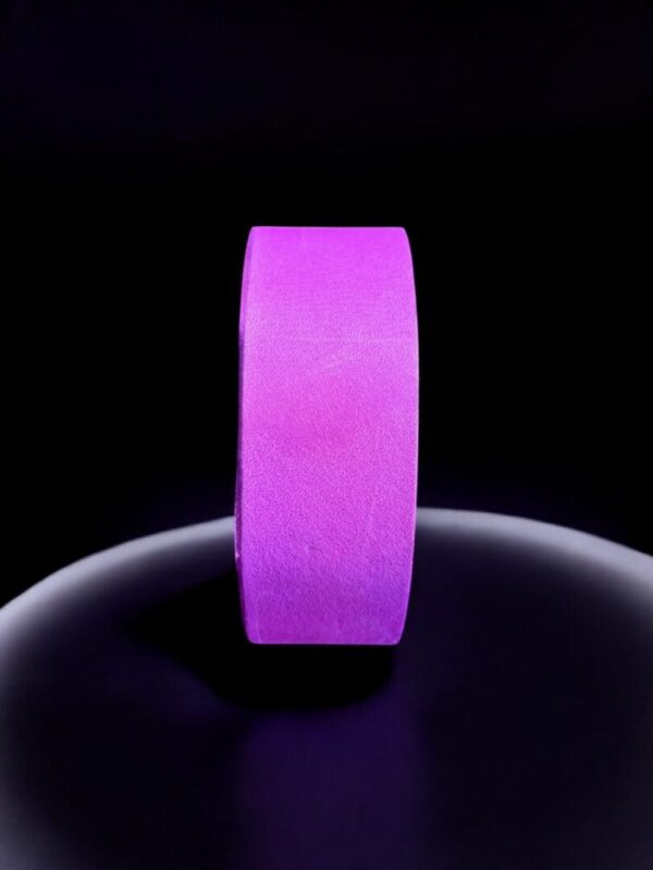 Purple tape roll on dark background.