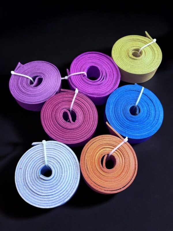 Colorful rolled ribbons on black background.