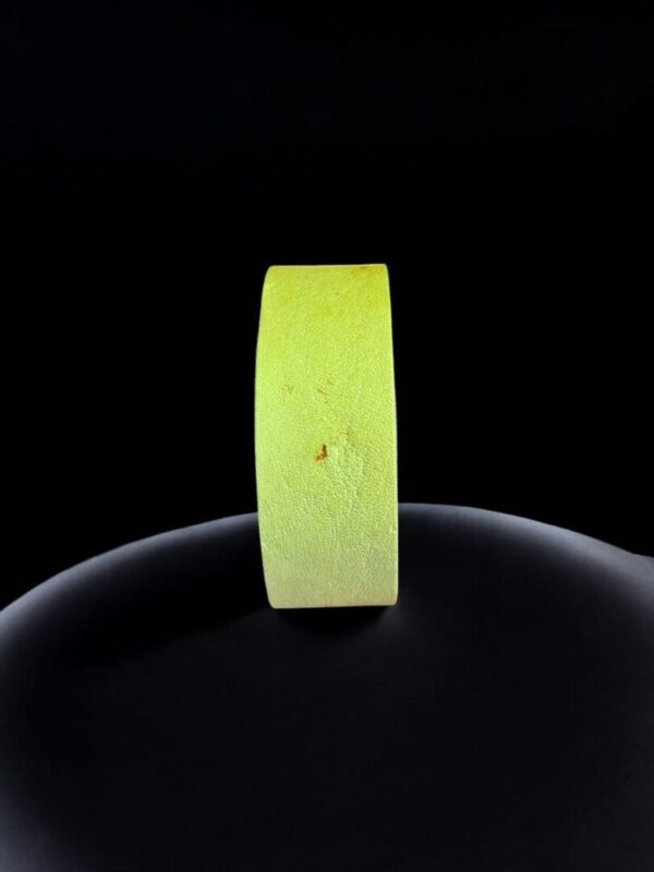 Yellow tape roll against black background.