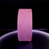 Pink roll of tape on black background.