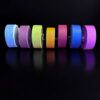 Colorful rolls of tape on black background.