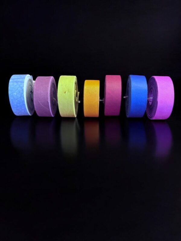 Colorful rolls of tape on black background.