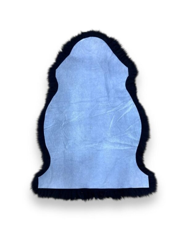 Blue sheepskin rug with black edging and trim.